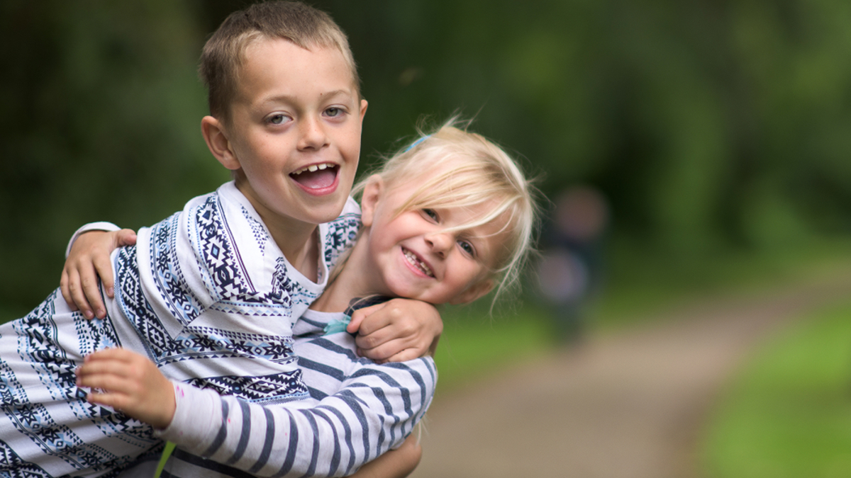 2 children hugging in a park
